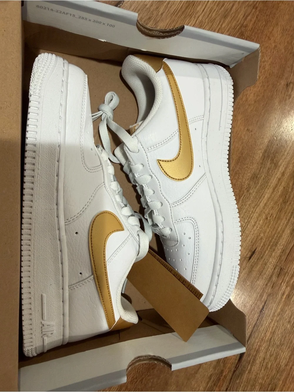 Nike Women's White Sneakers with Gold Swoosh
